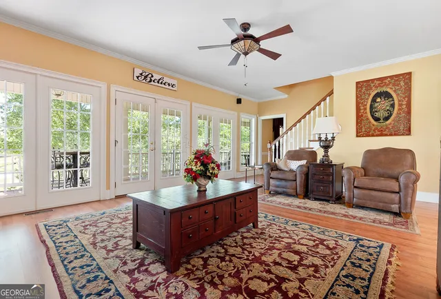 a living room with furniture a rug a fireplace and a flat screen tv