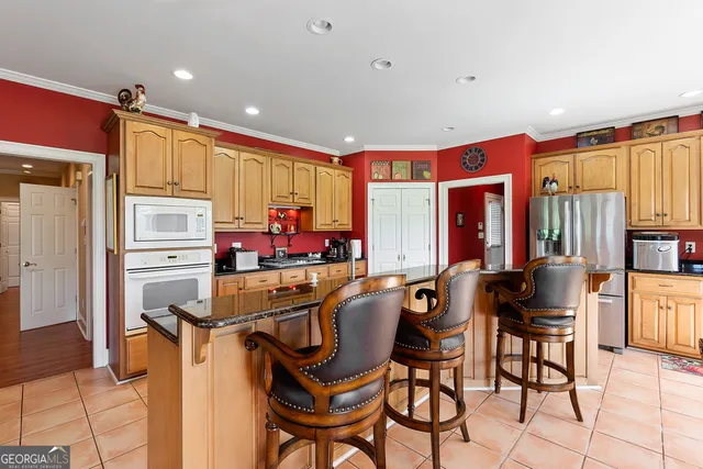 a kitchen with granite countertop a sink and cabinets