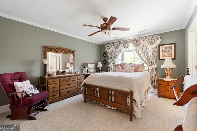 a bedroom with bed and a chandelier