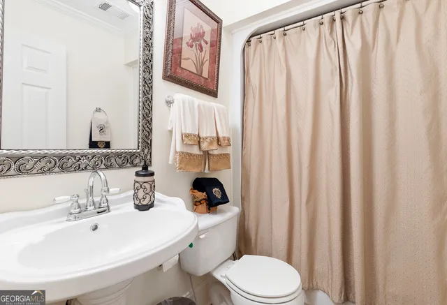 a living room with furniture a lamp and a large window