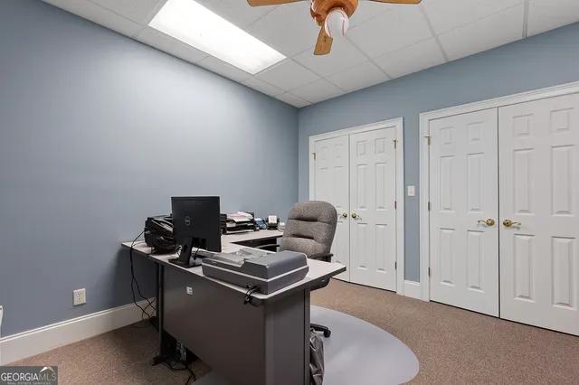 a bathroom with a sink and mirror with toilet