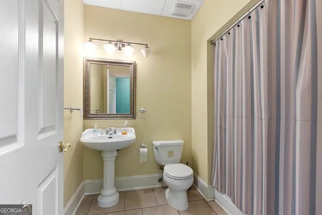 a living room with furniture and a ceiling fan