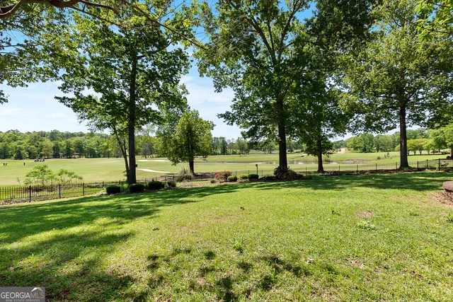 a front view of a house with a yard and potted plants