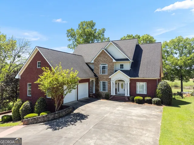 a view of a livingroom with wooden floor and a fireplace