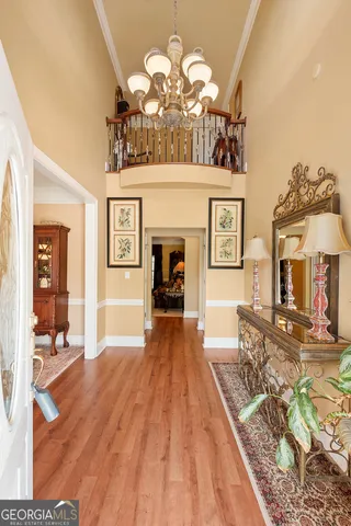a view of a a dining room with furniture window and wooden floor