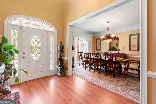 a view of a hallway and dining room and wooden floor