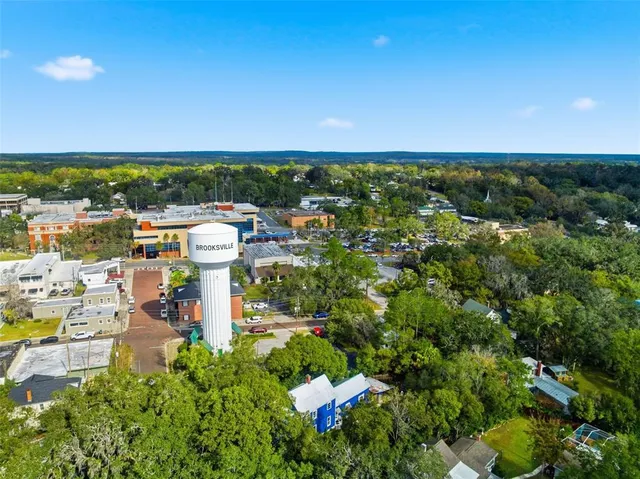 a view of a dining room with furniture wooden floor and a chandelier