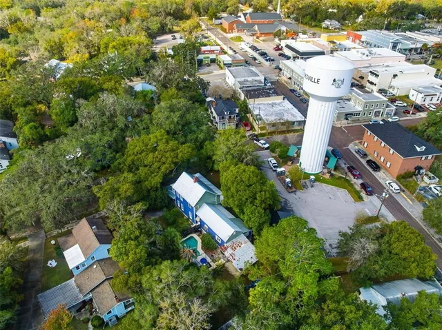 a large kitchen with stainless steel appliances lots of counter space and furniture