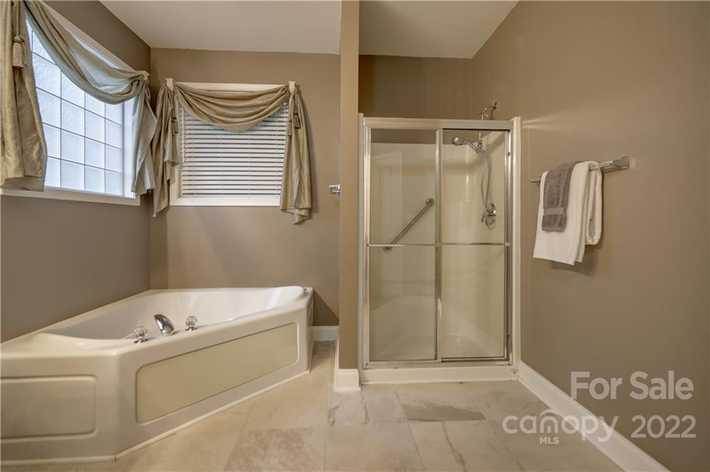 3229 Sapphire Lane Fort Mill, SC 29708 - Photo 16 of 40 a bathroom with a bathtub and shower