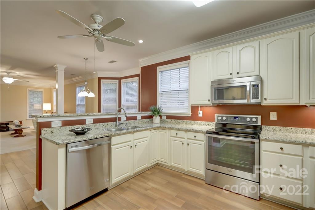3229 Sapphire Lane Fort Mill, SC 29708 - Photo 4 of 40 a kitchen with granite countertop a sink stainless steel appliances and cabinets