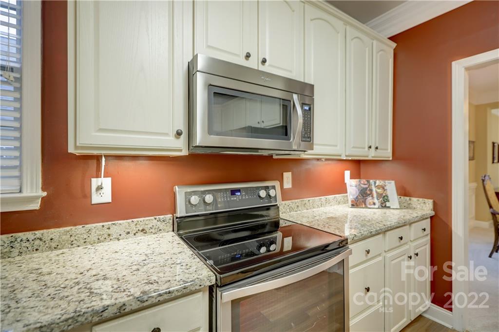 3229 Sapphire Lane Fort Mill, SC 29708 - Photo 6 of 40 a kitchen with granite countertop cabinets stainless steel appliances and wooden floor