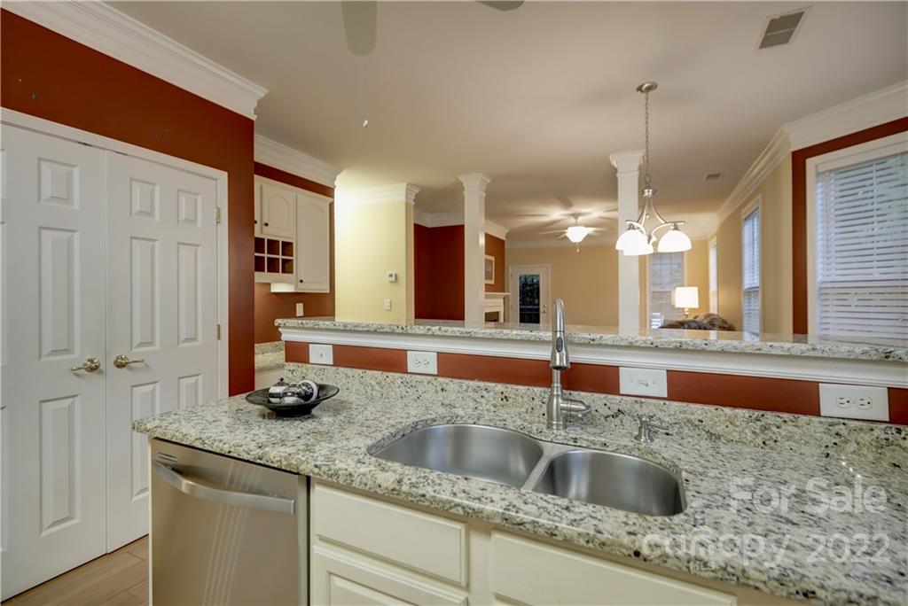 3229 Sapphire Lane Fort Mill, SC 29708 - Photo 7 of 40 a kitchen with stainless steel appliances granite countertop a sink a counter space and cabinets