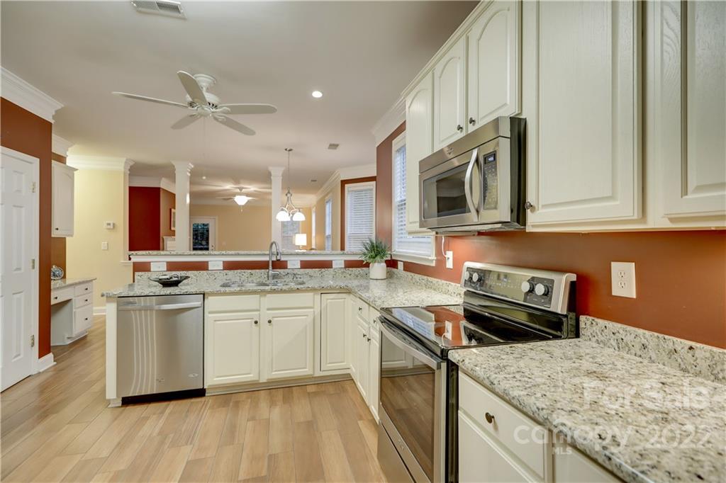 3229 Sapphire Lane Fort Mill, SC 29708 - Photo 8 of 40 a kitchen with stainless steel appliances granite countertop a sink stove and refrigerator