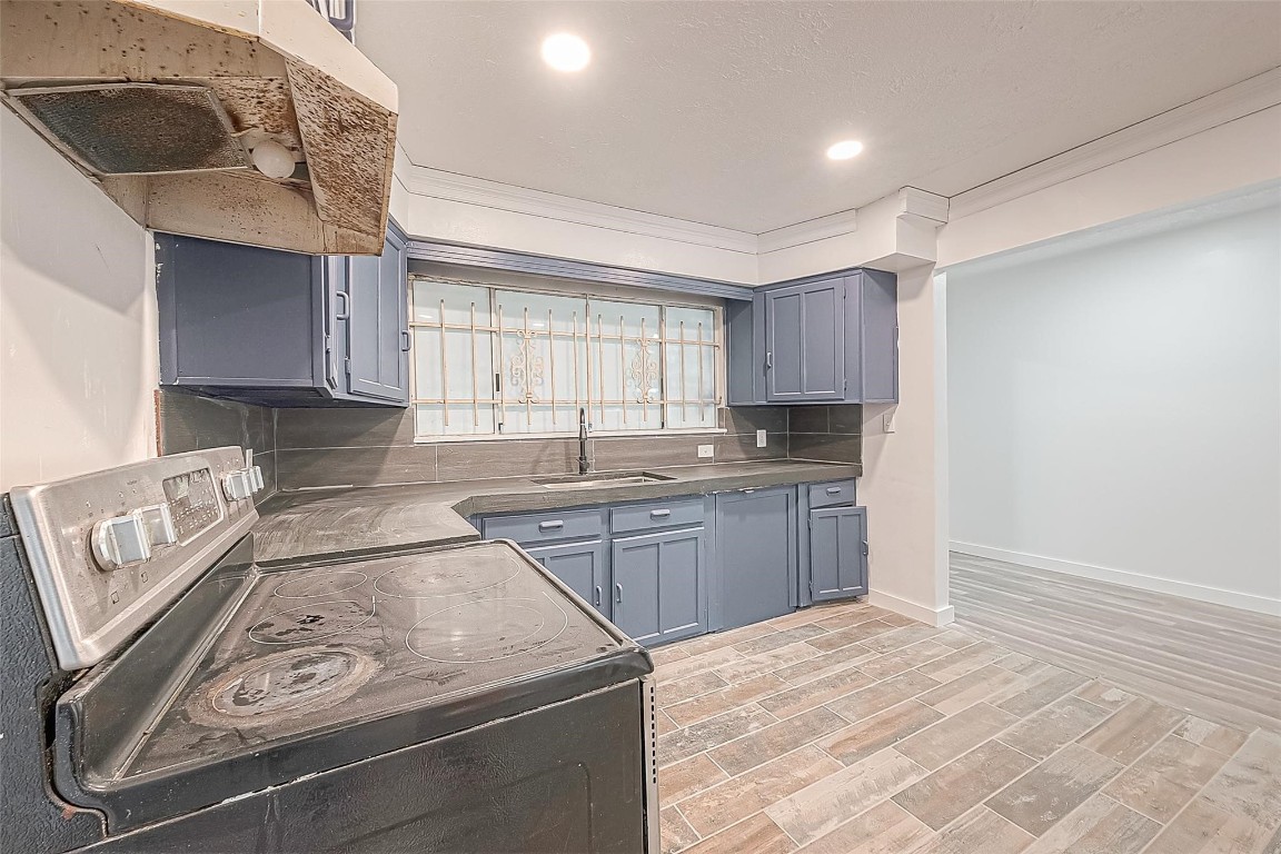 6718 Madrid Street Houston, TX 77021 - Photo 14 of 26 a kitchen with granite countertop a sink stove and cabinets
