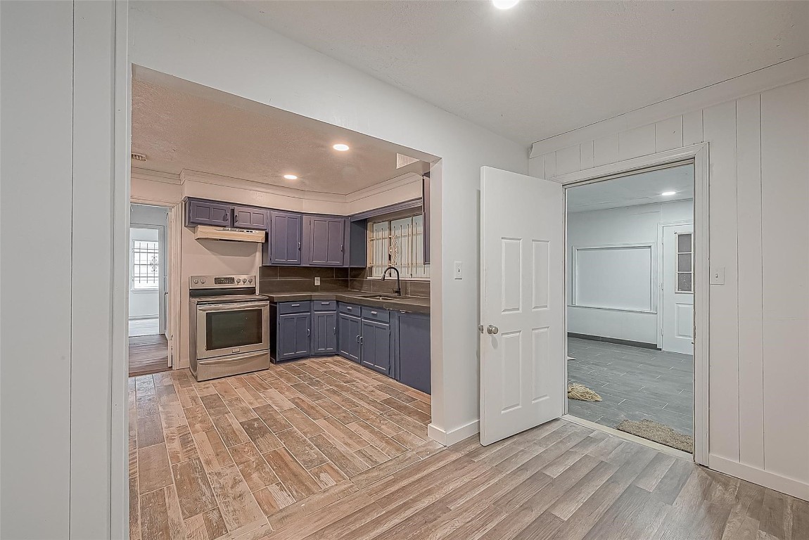 6718 Madrid Street Houston, TX 77021 - Photo 16 of 26 a kitchen with a refrigerator and a stove top oven