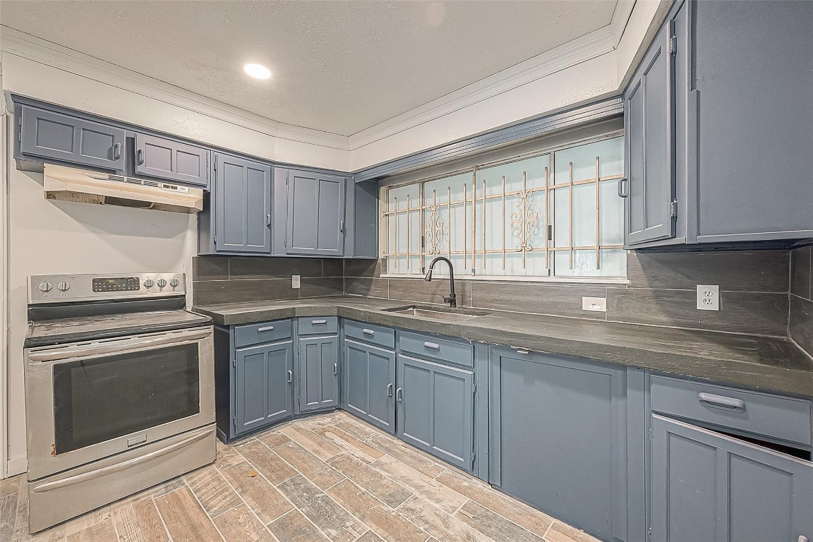 6718 Madrid Street Houston, TX 77021 - Photo 18 of 26 a kitchen with a sink stove and cabinets