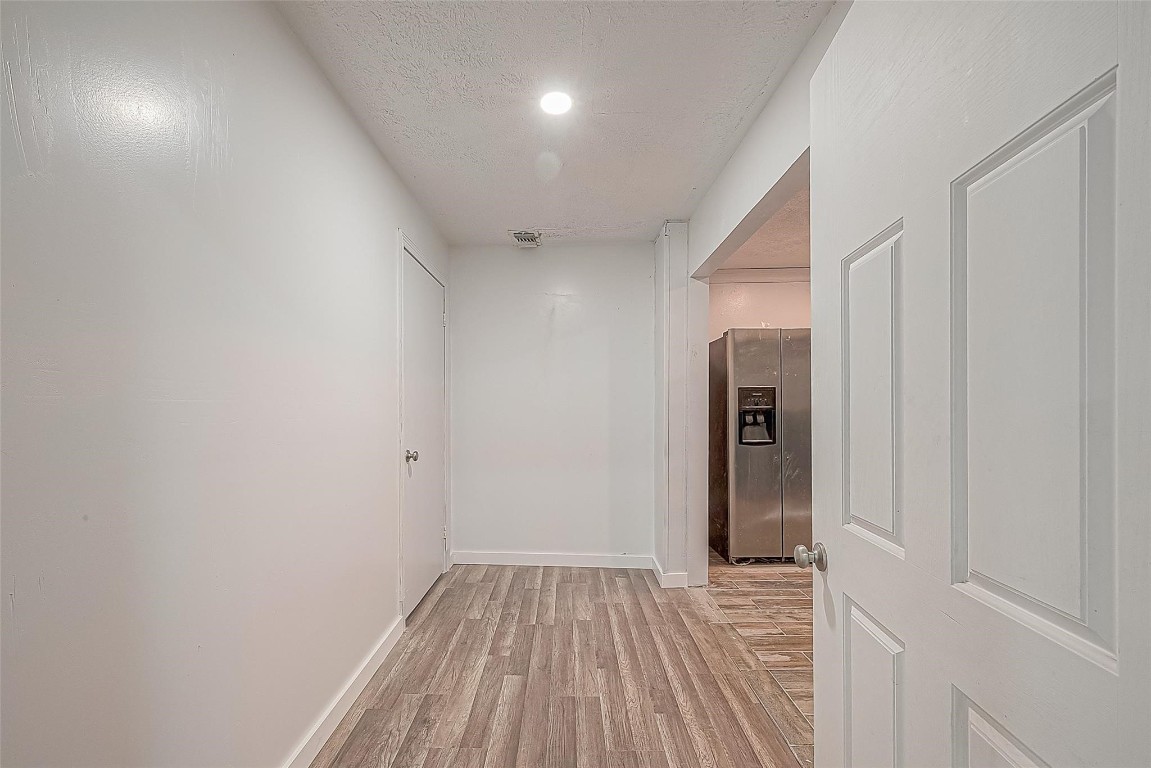 6718 Madrid Street Houston, TX 77021 - Photo 21 of 26 a view of hallway with wooden floor