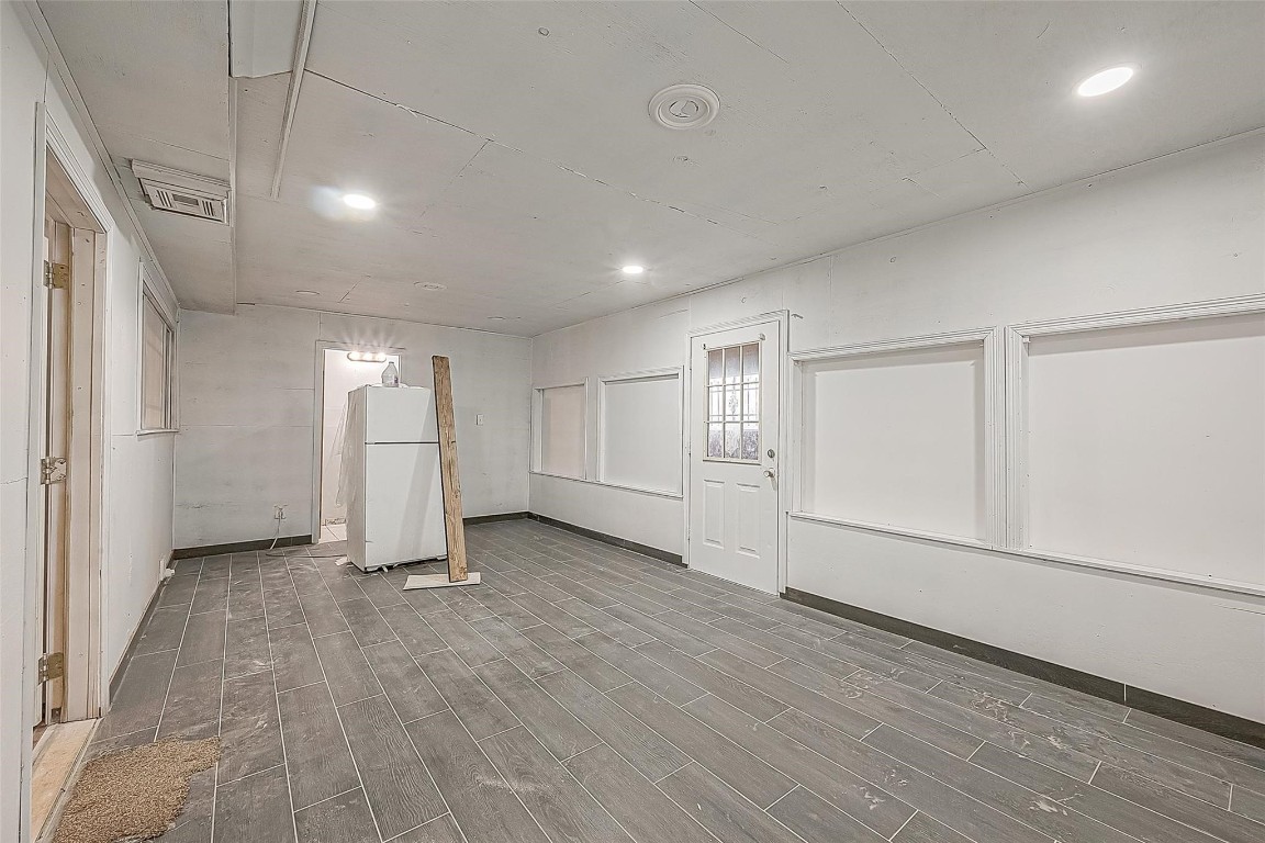 6718 Madrid Street Houston, TX 77021 - Photo 23 of 26 an empty room with wooden floor and windows