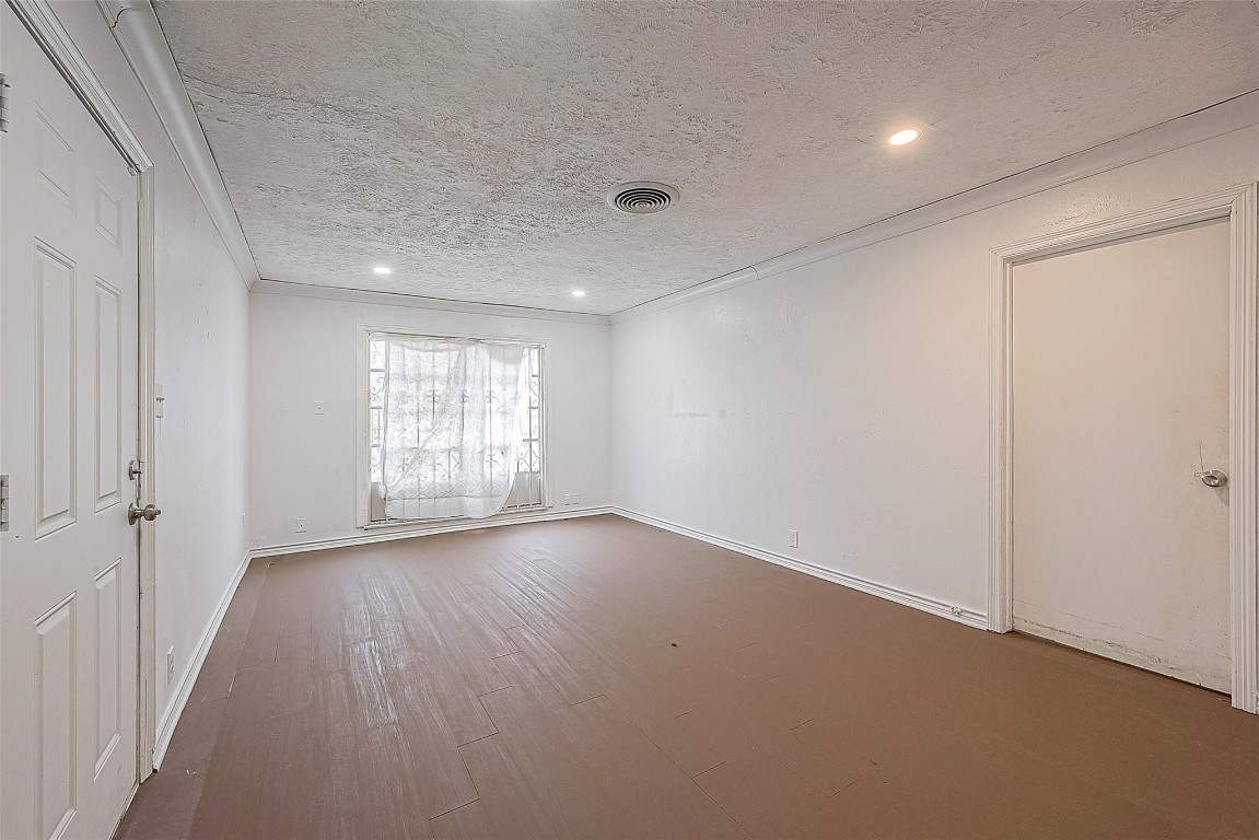 6718 Madrid Street Houston, TX 77021 - Photo 7 of 26 wooden floor in an empty room with a window