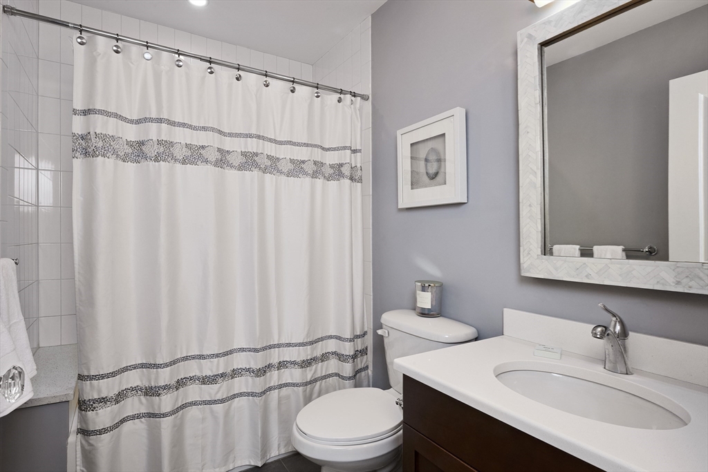 870 East 4th Street, Unit 2 Boston, MA 02127 - Photo 14 of 20 a bathroom with a sink a toilet and a mirror