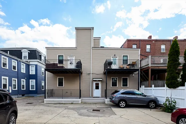 a front view of a residential apartment building with a yard