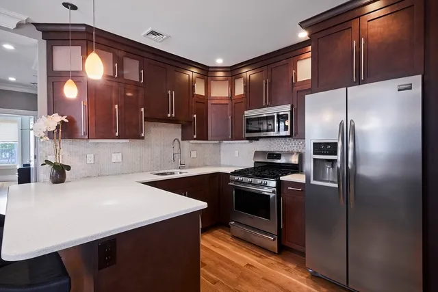 a kitchen with stainless steel appliances a refrigerator and a stove