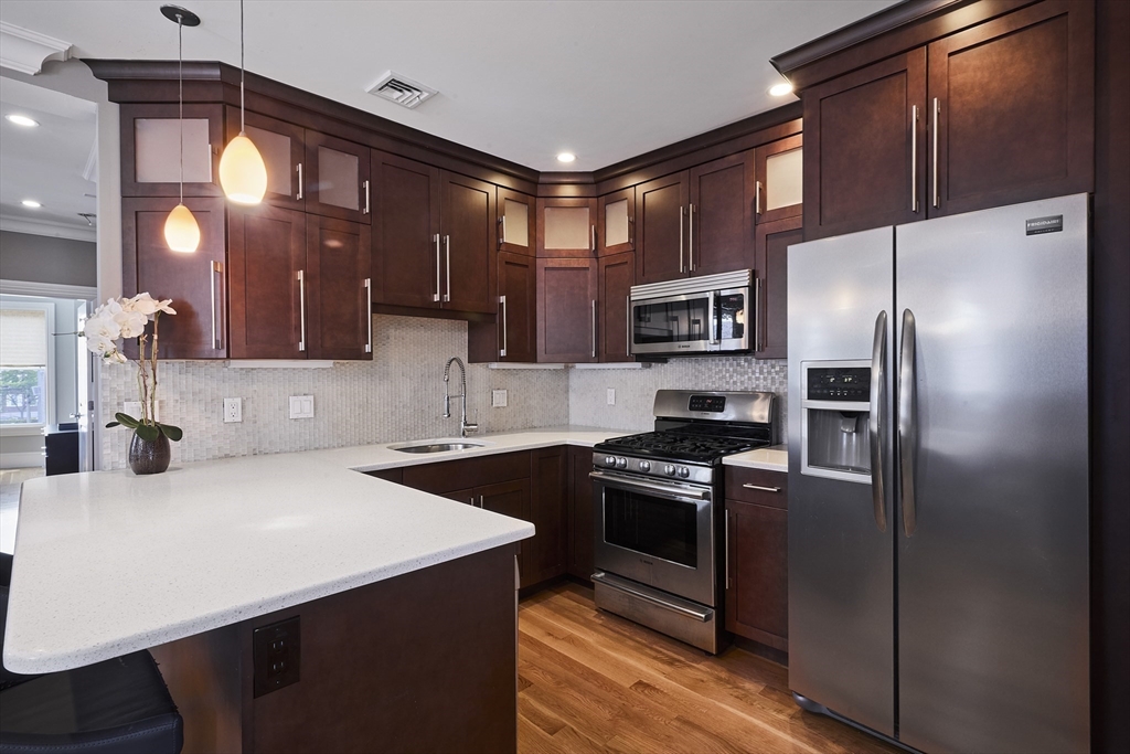 870 East 4th Street, Unit 2 Boston, MA 02127 - Photo 4 of 20 a kitchen with stainless steel appliances a refrigerator and a stove
