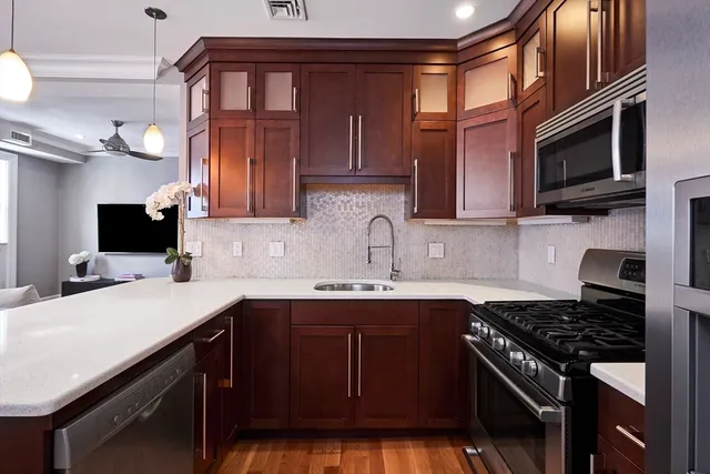 a kitchen with a sink stove top oven and cabinets