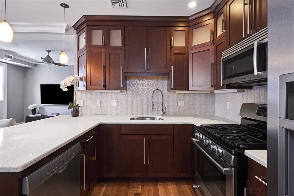 870 East 4th Street, Unit 2 Boston, MA 02127 - Photo 5 of 20 a kitchen with a sink stove top oven and cabinets