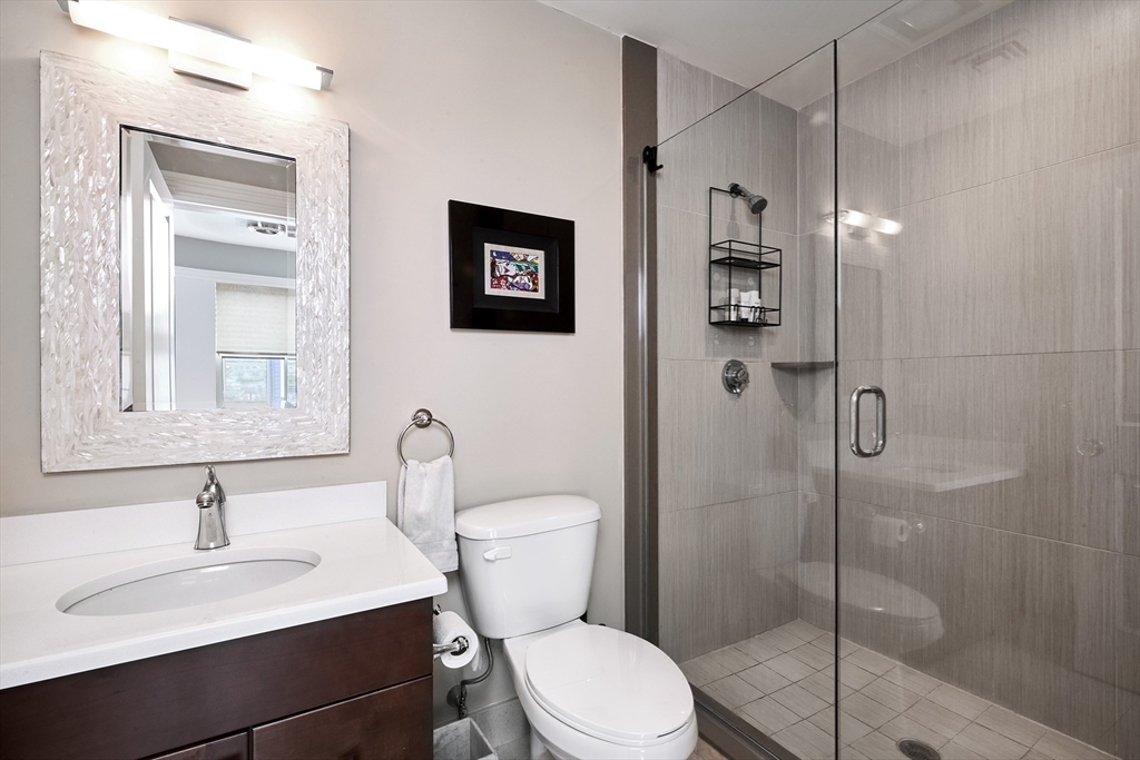 870 East 4th Street, Unit 2 Boston, MA 02127 - Photo 7 of 20 a bathroom with a toilet sink vanity granite and shower