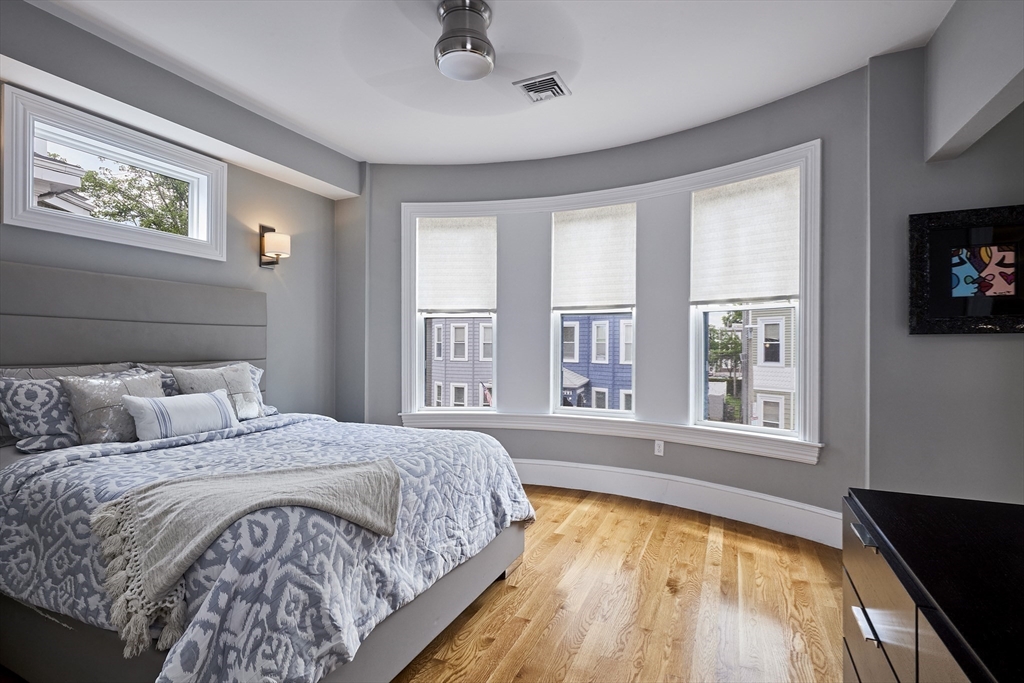 870 East 4th Street, Unit 2 Boston, MA 02127 - Photo 8 of 20 a bed sitting in a bedroom next to a window