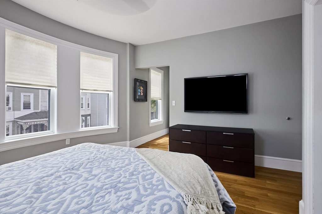 870 East 4th Street, Unit 2 Boston, MA 02127 - Photo 9 of 20 a bedroom with a bed and a flat screen tv