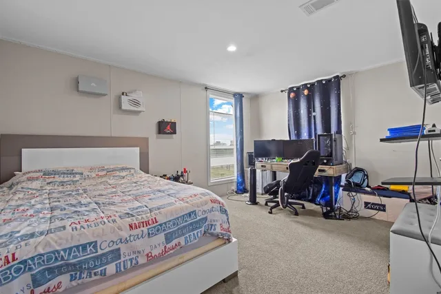 a bedroom with a bed and a tv on table