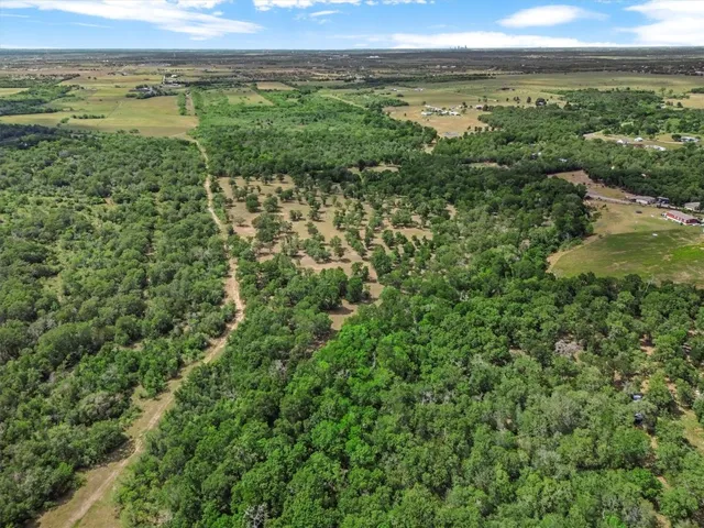 a view of a green field with an outdoor space