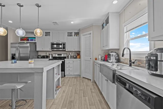 a kitchen with a sink stove and cabinets