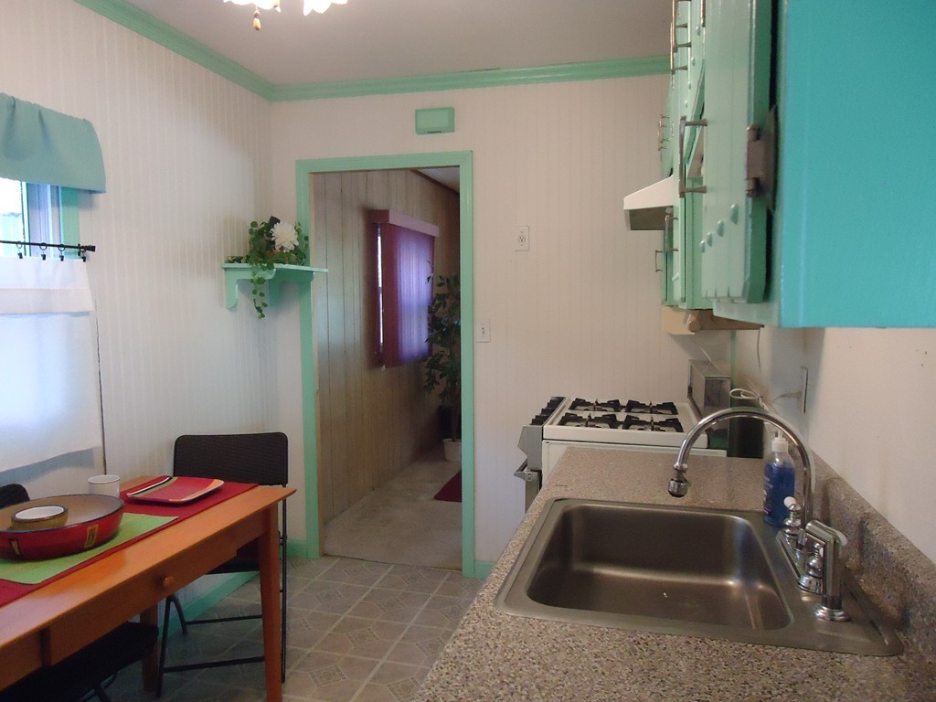 68 Victoria Street Springfield, MA 01104 - Photo 4 of 14 a kitchen with a sink cabinets and stove