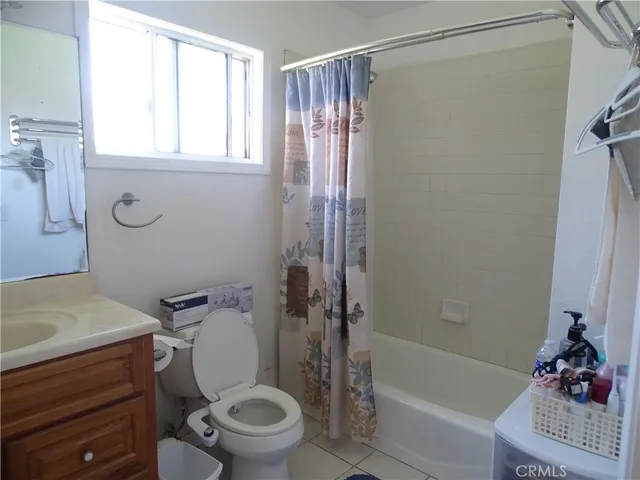 a white toilet sitting next to a bath tub shower