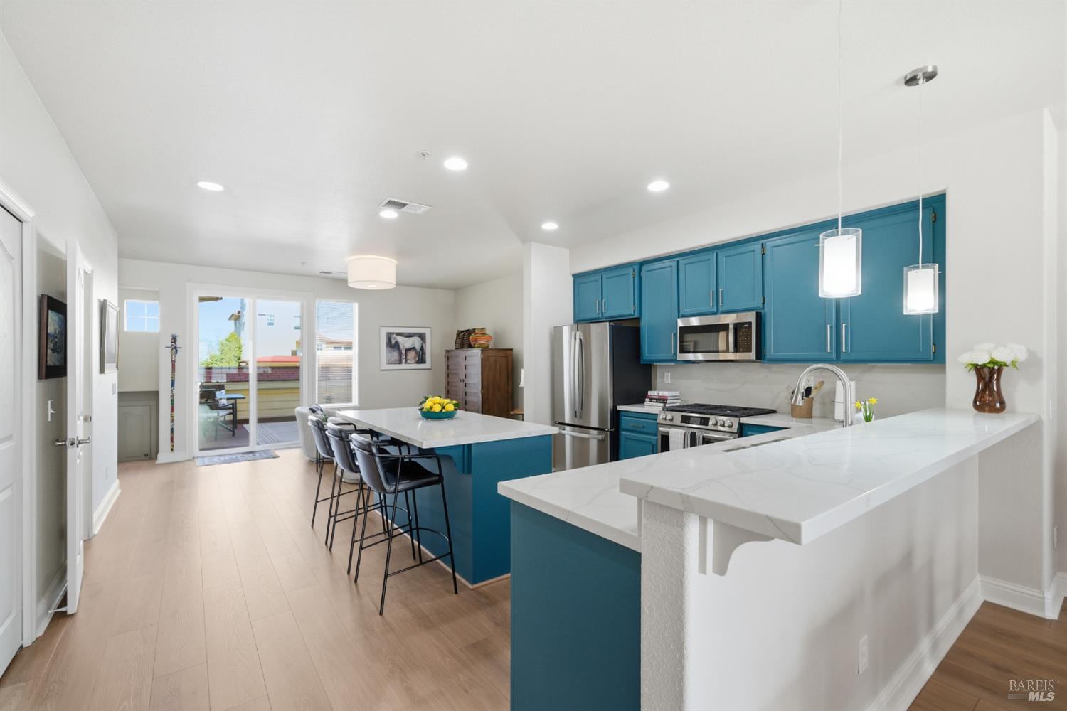 191 Johnson Street Windsor, CA 95492 - Photo 14 of 34 a kitchen with stainless steel appliances a table chairs refrigerator and microwave