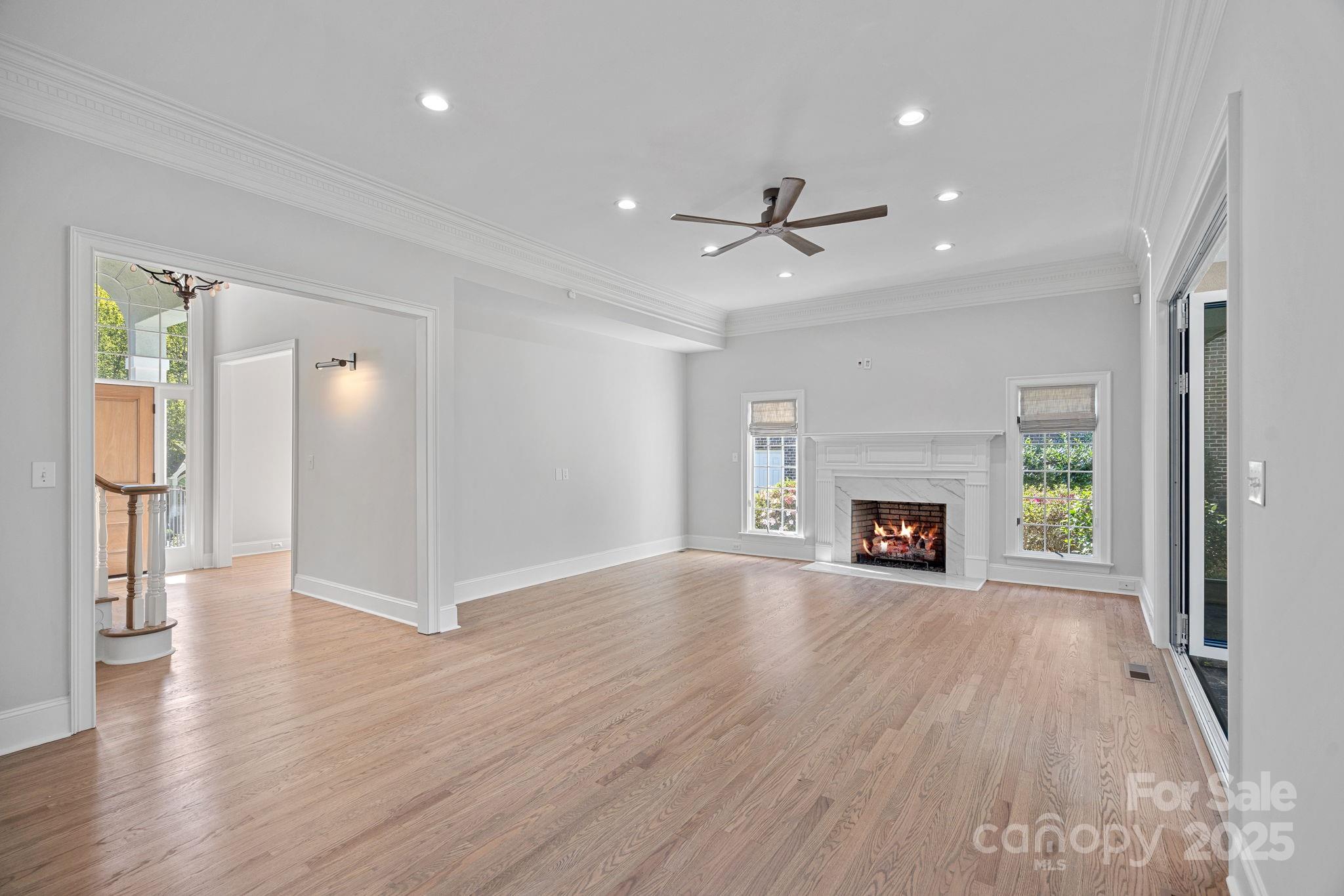 17608 River Ford Drive Davidson, NC 28036 - Photo 11 of 48 an empty room with wooden floor fireplace and windows