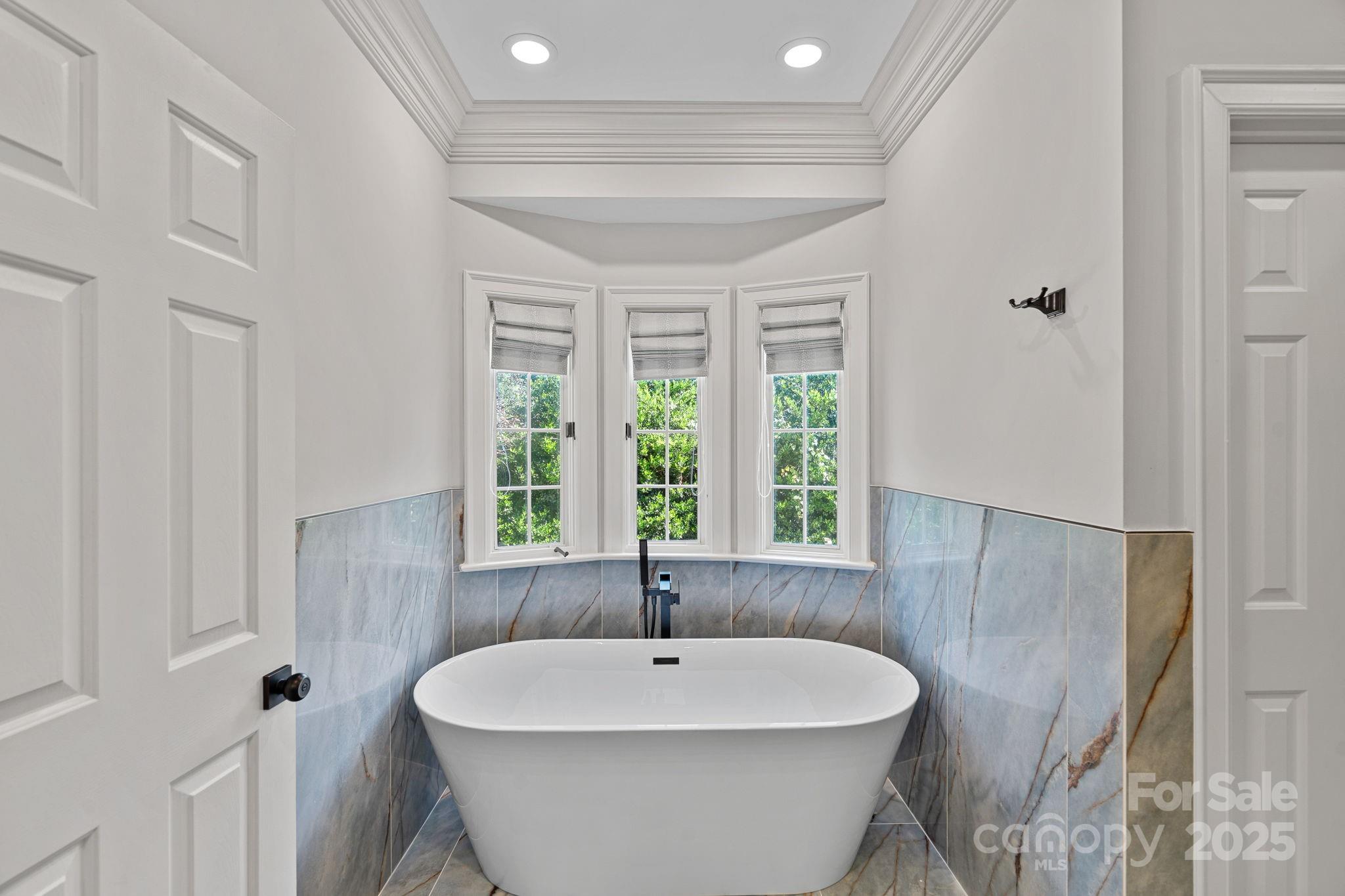 17608 River Ford Drive Davidson, NC 28036 - Photo 25 of 48 a white bath tub sitting in a bathroom next to a window