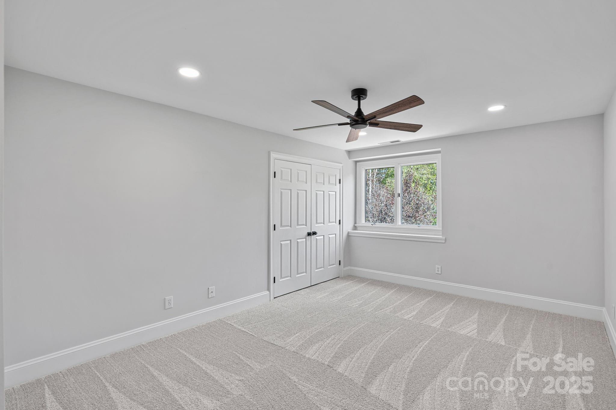 17608 River Ford Drive Davidson, NC 28036 - Photo 30 of 48 a view of a livingroom with a ceiling fan & windows
