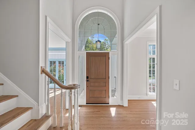 a view of an entryway with wooden floor