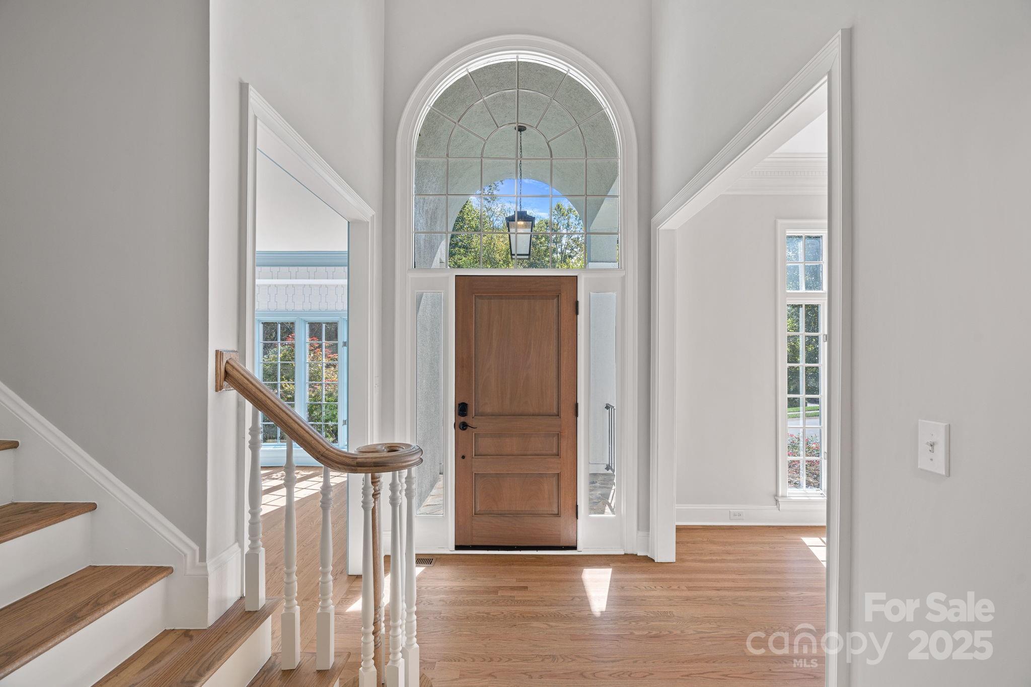 17608 River Ford Drive Davidson, NC 28036 - Photo 3 of 48 a view of a hallway with entryway wooden floor and front door