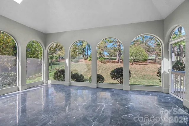 a view of balcony with wooden floor and fence