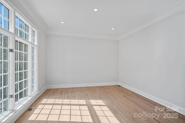 a view of an empty room with a fireplace and a window