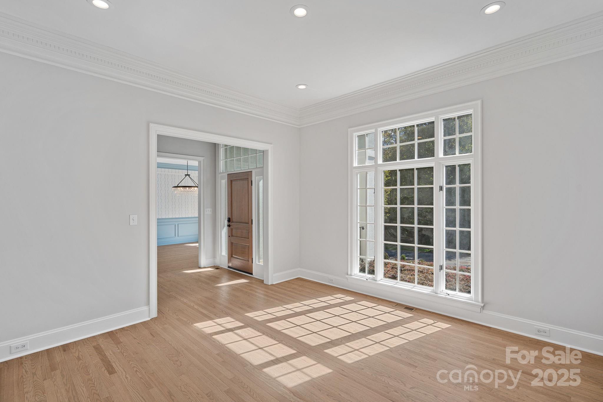17608 River Ford Drive Davidson, NC 28036 - Photo 8 of 48 a view of an empty room with wooden floor and a window