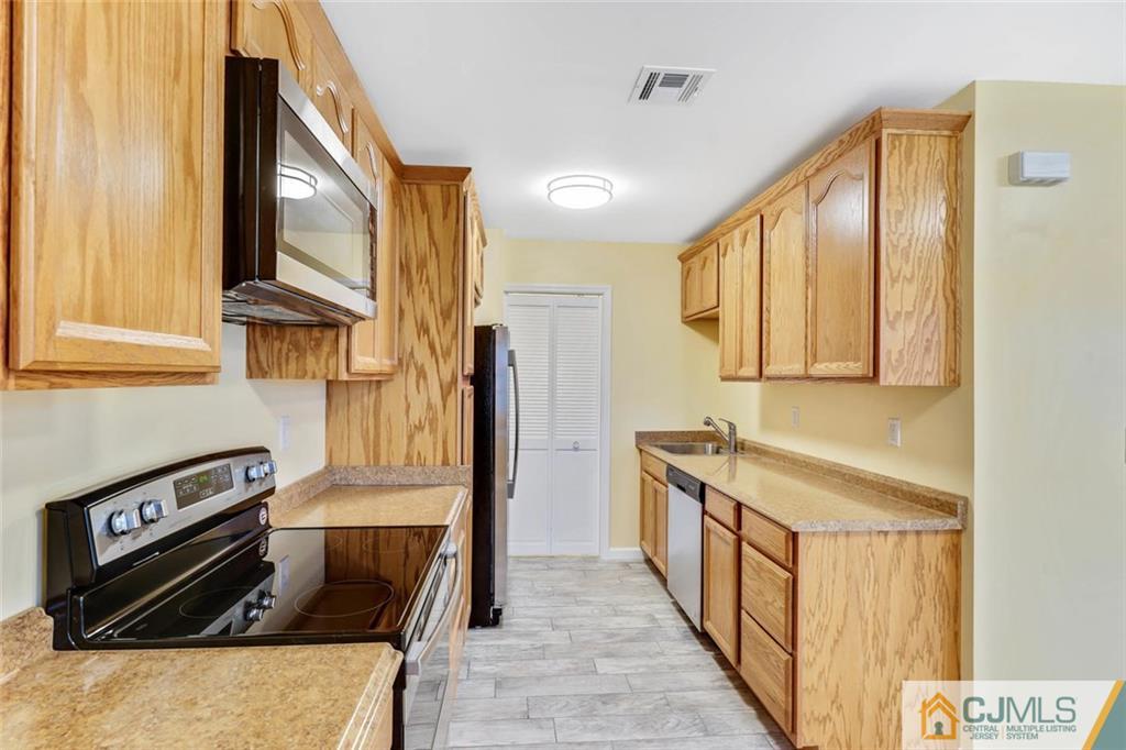 3 Valery Road Old Bridge, NJ 07747 - Photo 11 of 19 a kitchen with stainless steel appliances granite countertop a stove a sink and a refrigerator