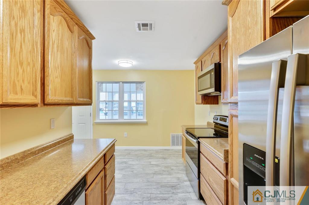 3 Valery Road Old Bridge, NJ 07747 - Photo 13 of 19 a kitchen with stainless steel appliances granite countertop a refrigerator and a stove top oven