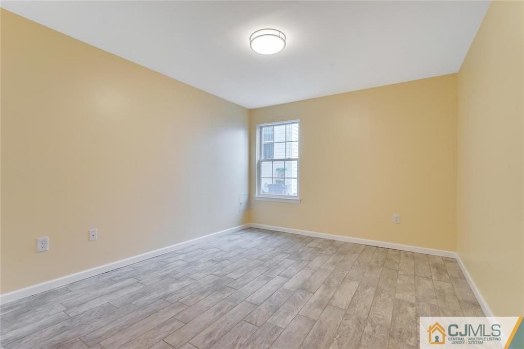 3 Valery Road Old Bridge, NJ 07747 - Photo 18 of 19 an empty room with wooden floor and windows