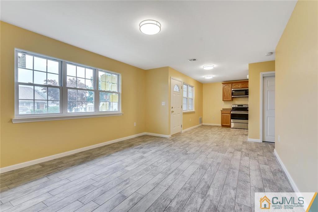 3 Valery Road Old Bridge, NJ 07747 - Photo 8 of 19 a view of an empty room with a window and wooden floor